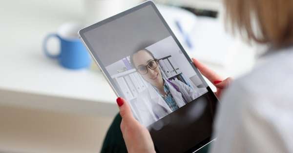 Woman Using Telemedicine Talking to Doctor on her Tablet